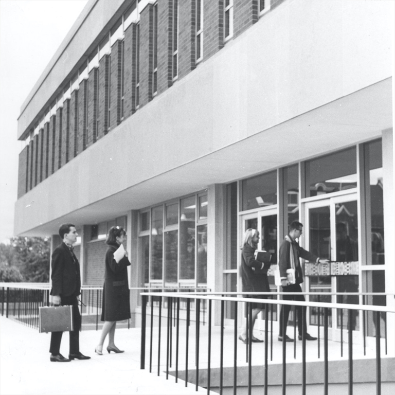 Black and white shot of students walking into the laurier library 